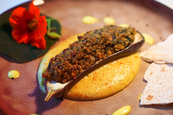 Eggplant with vegetables-quinoa filling with mashed potatoes accompanied by roasted parsnips